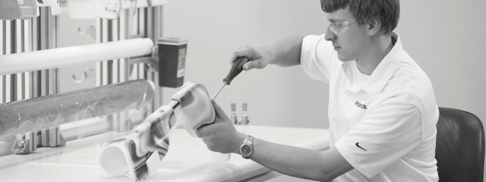 man building a custom afo brace in a workshop