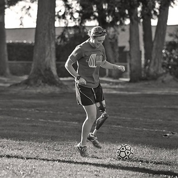 woman playing soccer with genium